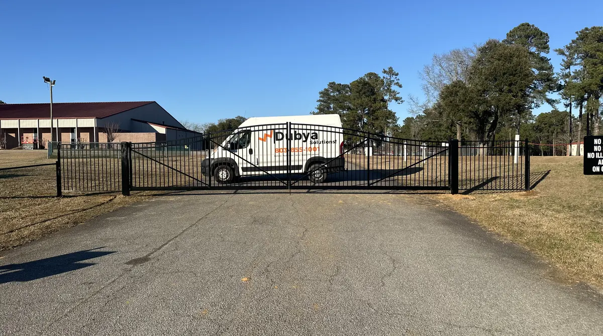 Fence company in Orangeburg SC - Dubya LLC with branded service van and ornamental gate